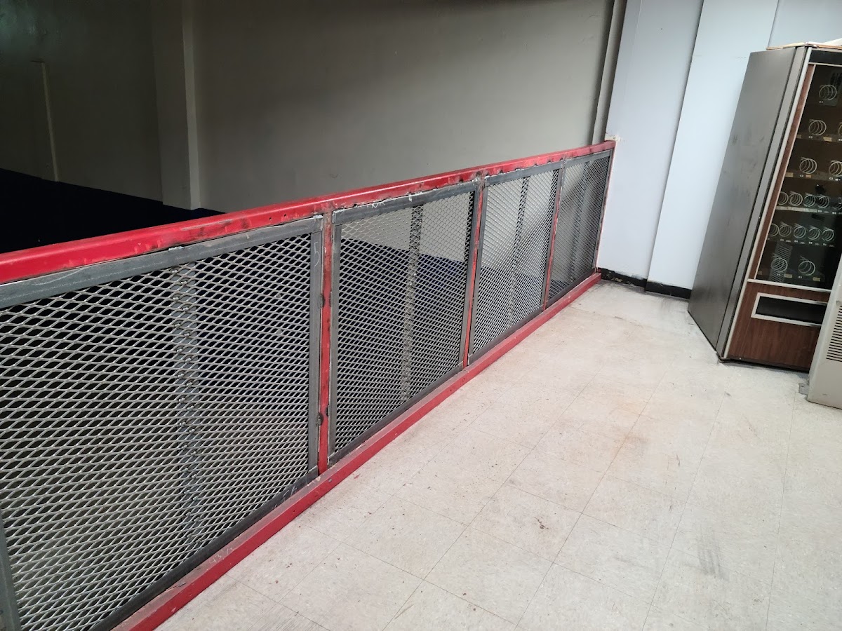 Custom-fabricated expanded metal security cage with red-painted steel frame